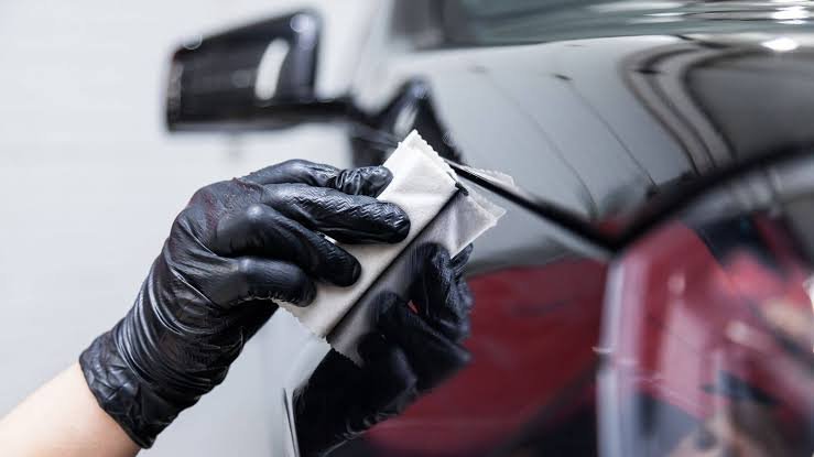 Machine polishing a red car